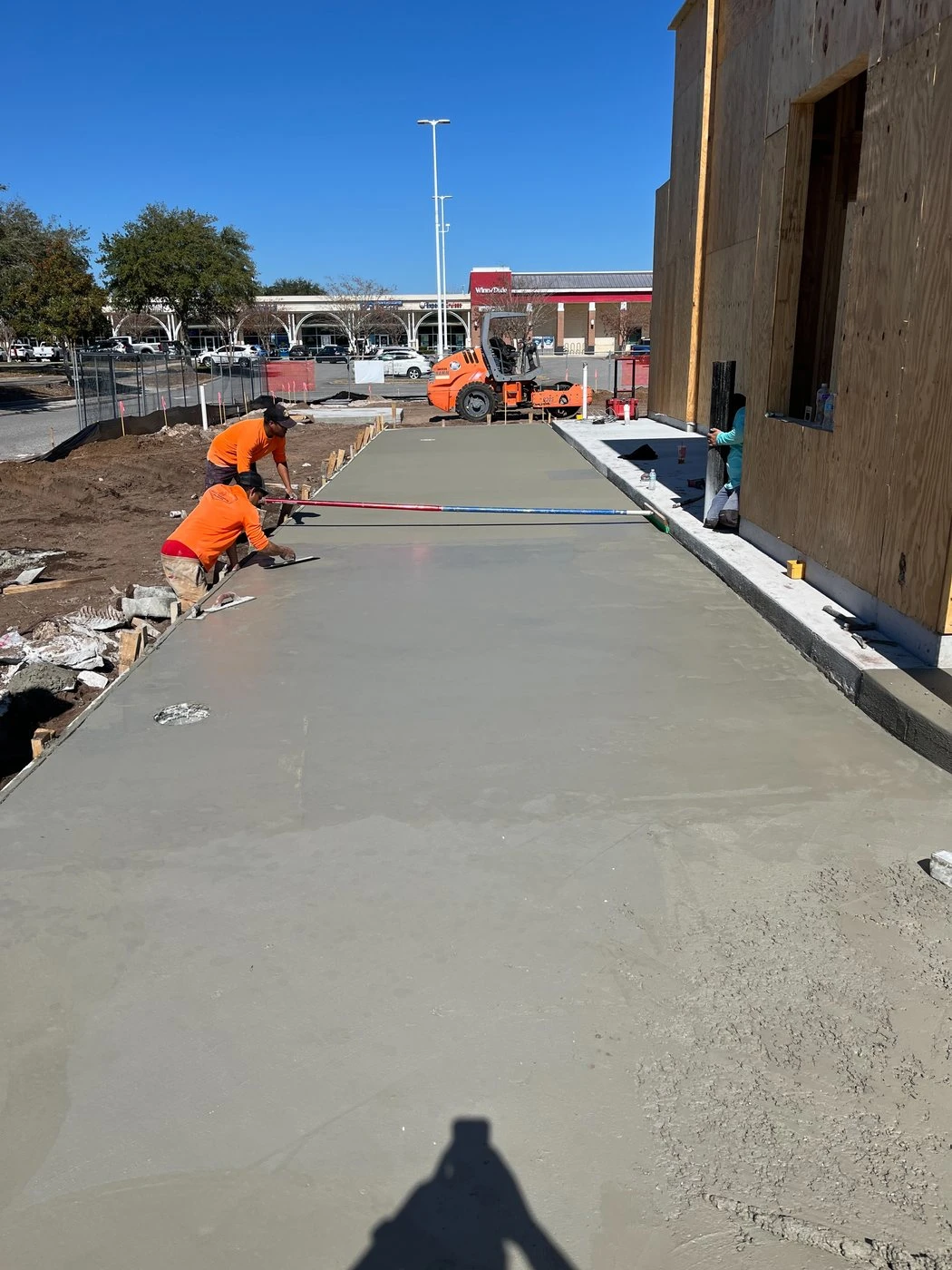 Concrete crew finishing the exterior pad at Dutch Bros Baymeadows.